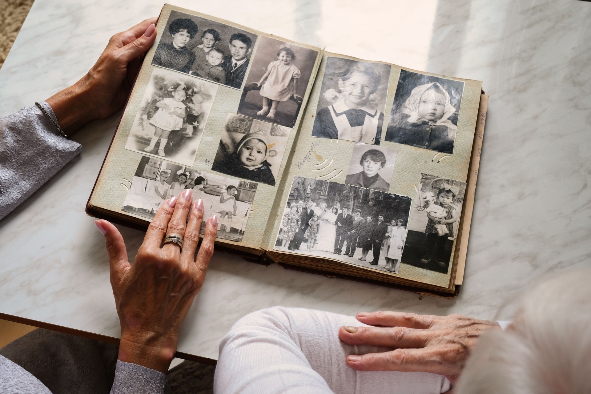 Senior couple looking through vintage photo album, nostalgic family memories